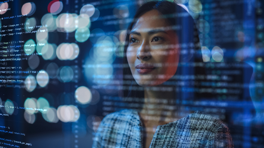 A woman analyzes code on a computer screen, embodying innovation and digital transformation in her work environment. A woman analyzes code on a computer screen, embodying innovation and digital transformation in her work environment.