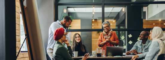 A diverse group of passionate professionals seated at a table, actively sharing ideas in an office space. A diverse group of passionate professionals seated at a table, actively sharing ideas in an office space.