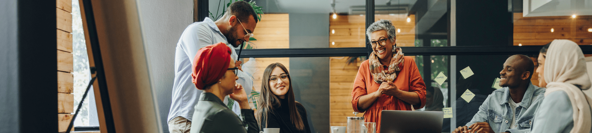 A diverse office team gathered around a table finding solutions to workforce problems