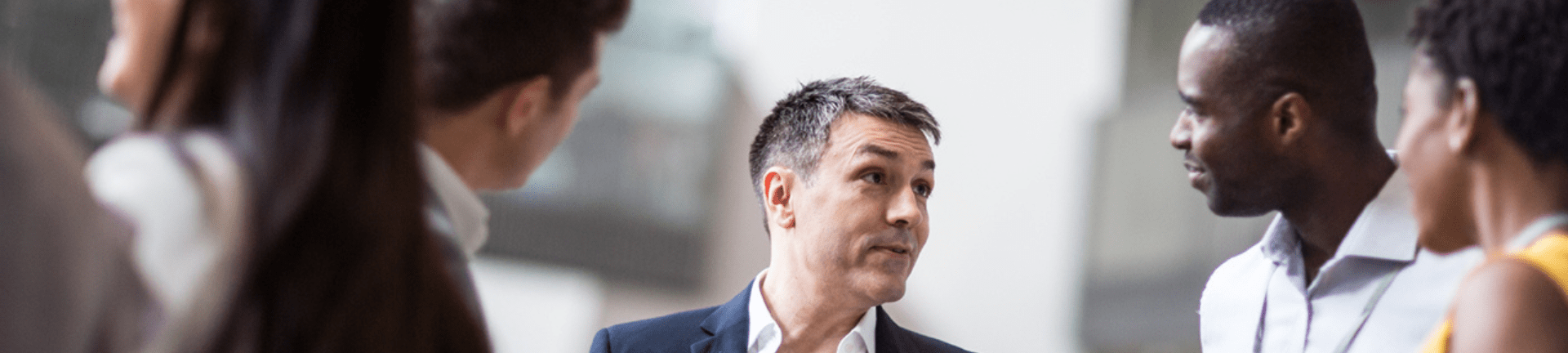 Two professionals standing next to each other in a room, collaborating on workforce MSP solutions.