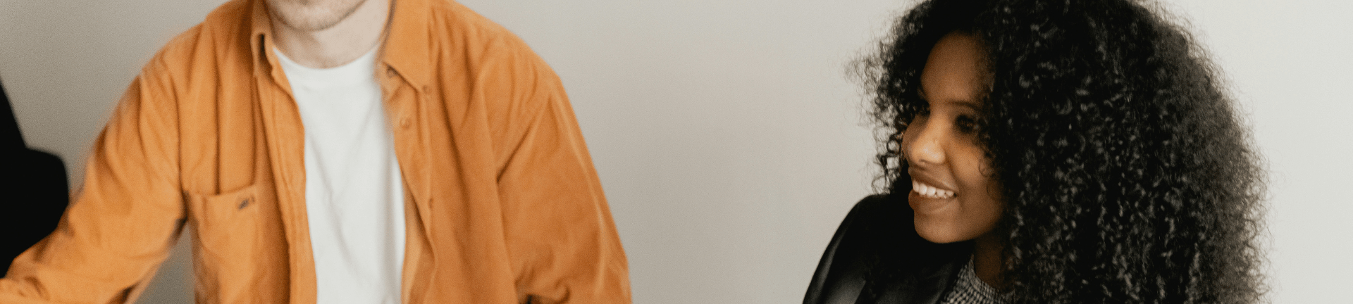 Two individuals engaged in discussion about MSP services procurement while sitting next to each other in a room.